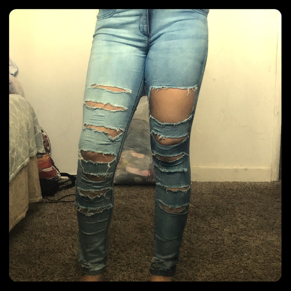 Hand designed ripped jeans with light blue wash